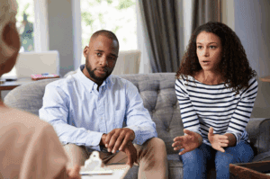 A couple speaks with a therapist